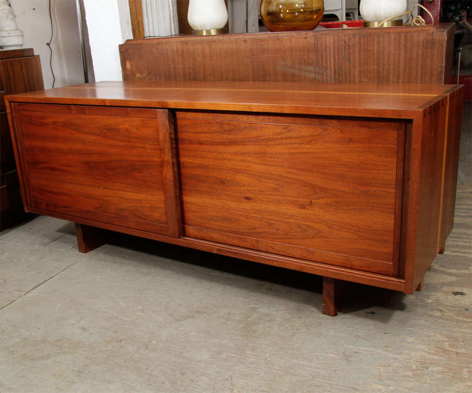 Beautiful low credenza by George Nakashima. Exquisitely detailed in black walnut.